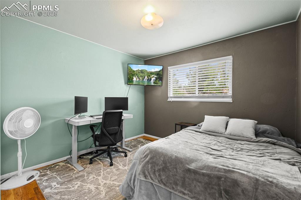 3716 Indianpipe Circle Colorado Springs, CO 80918 - Photo 15 of 33 a bedroom with a bed and a desk