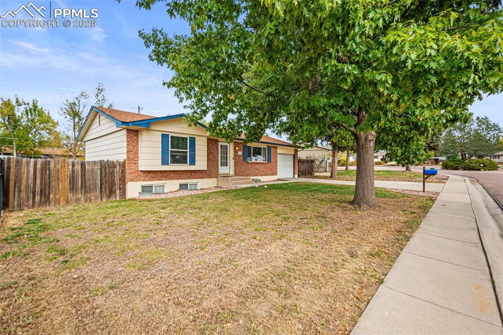 3716 Indianpipe Circle Colorado Springs, CO 80918 - Photo 3 of 33 a front view of a house with a garden