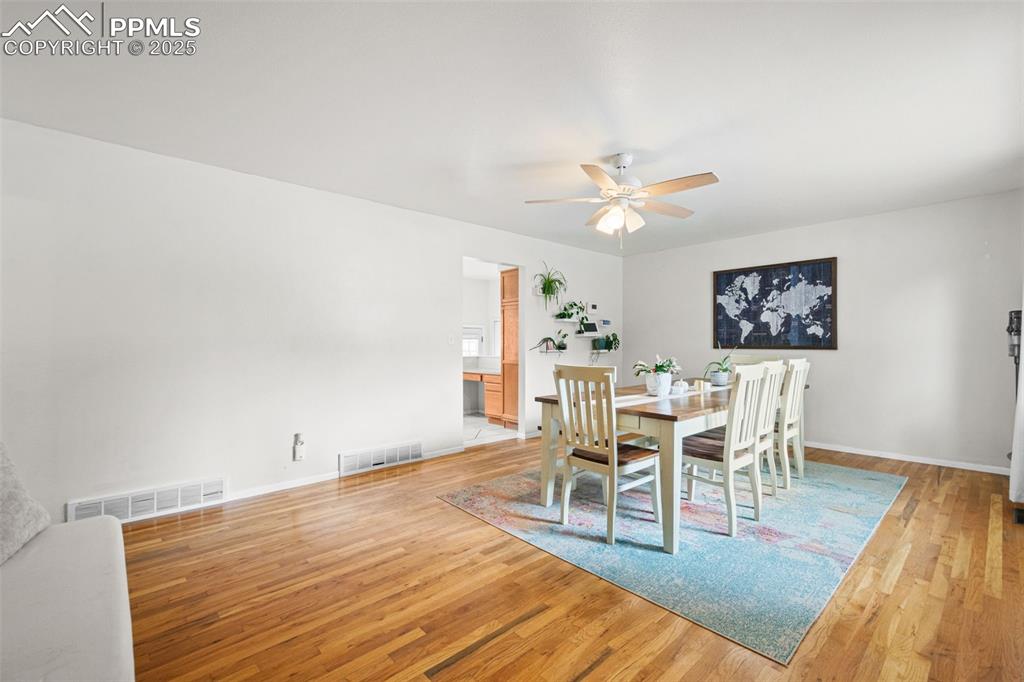 3716 Indianpipe Circle Colorado Springs, CO 80918 - Photo 4 of 33 a view of a dining room with furniture and wooden floor