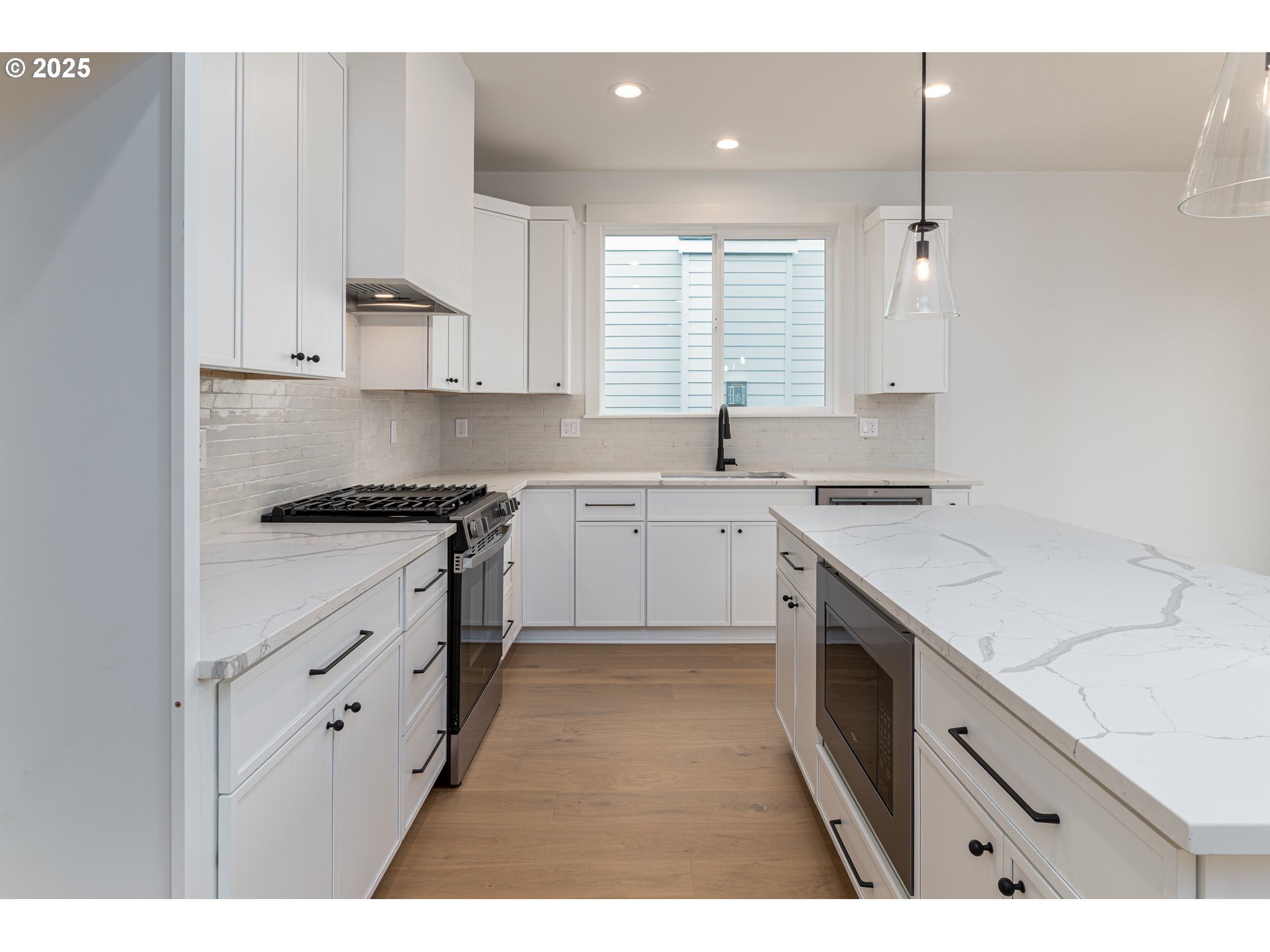 2263 Southwest Phyllis Place Gresham, OR 97080 - Photo 9 of 34 a kitchen with white cabinets sink and stove