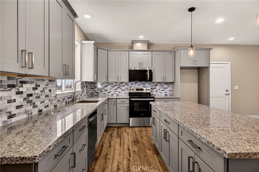 5617 Scottwood Road Paradise, CA 95969 - Photo 12 of 55 a kitchen with stainless steel appliances granite countertop a sink stove and refrigerator