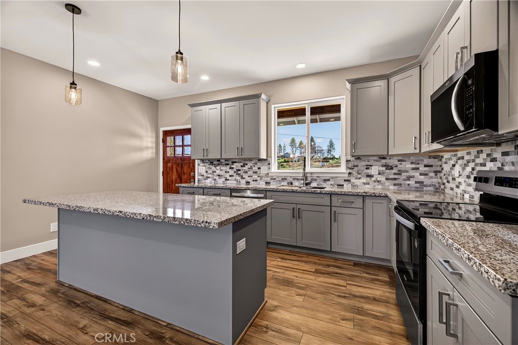 5617 Scottwood Road Paradise, CA 95969 - Photo 13 of 55 a kitchen with stainless steel appliances granite countertop a sink stove and refrigerator