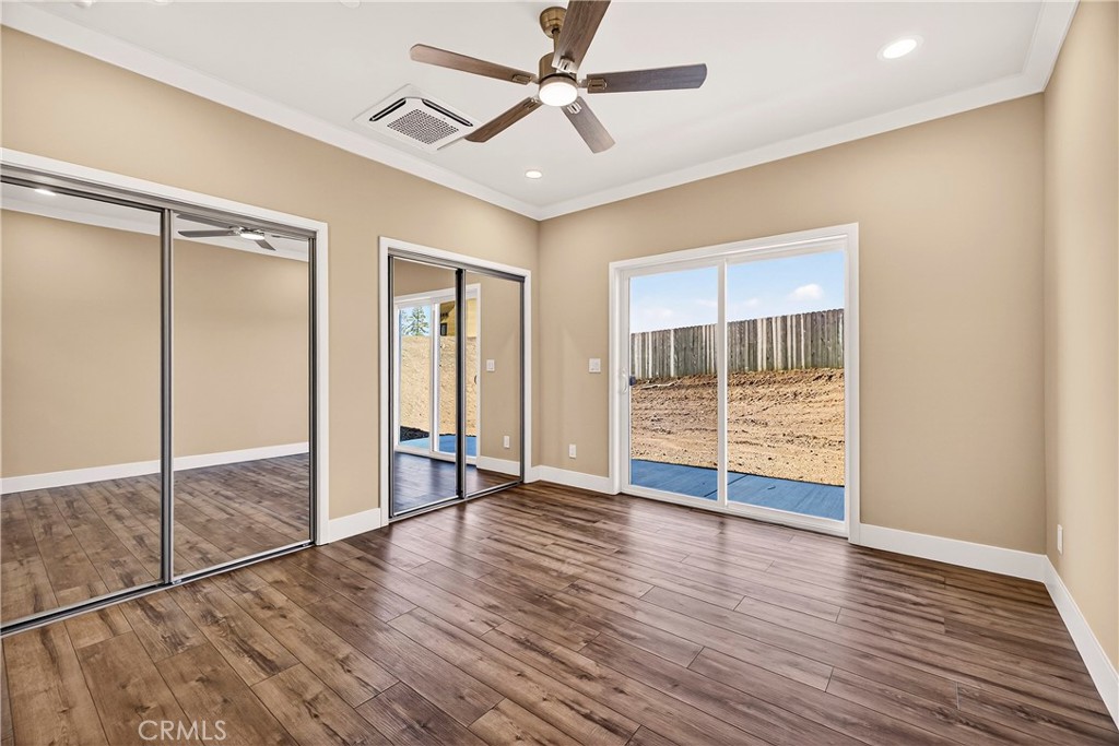 5617 Scottwood Road Paradise, CA 95969 - Photo 19 of 55 an empty room with wooden floor and windows