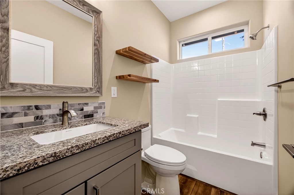 5617 Scottwood Road Paradise, CA 95969 - Photo 27 of 55 a bathroom with a granite countertop sink a toilet and shower