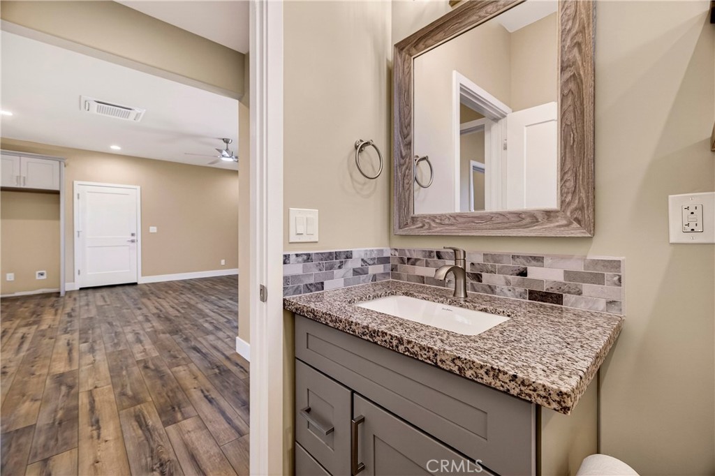5617 Scottwood Road Paradise, CA 95969 - Photo 28 of 55 a bathroom with a granite countertop sink and a mirror