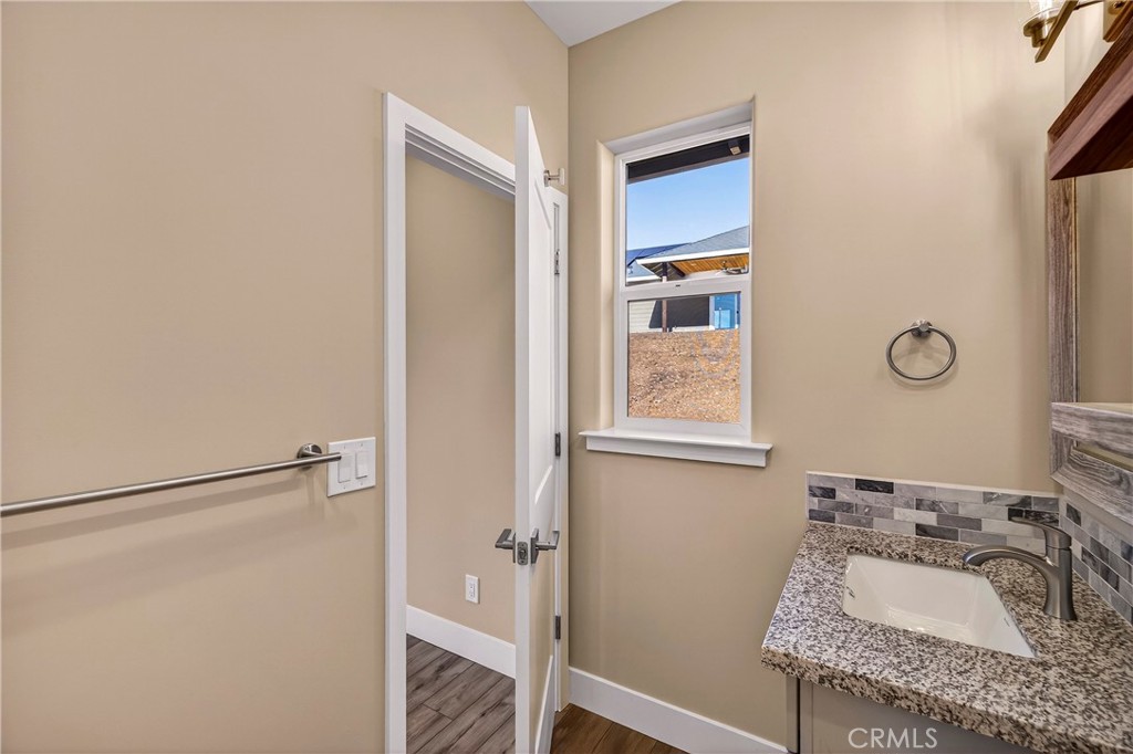 5617 Scottwood Road Paradise, CA 95969 - Photo 29 of 55 a bathroom with a granite countertop sink a mirror and shower
