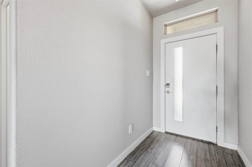 348 Braves Way Lavon, TX 75166 - Photo 14 of 26 a view of an empty room with wooden floor and a window