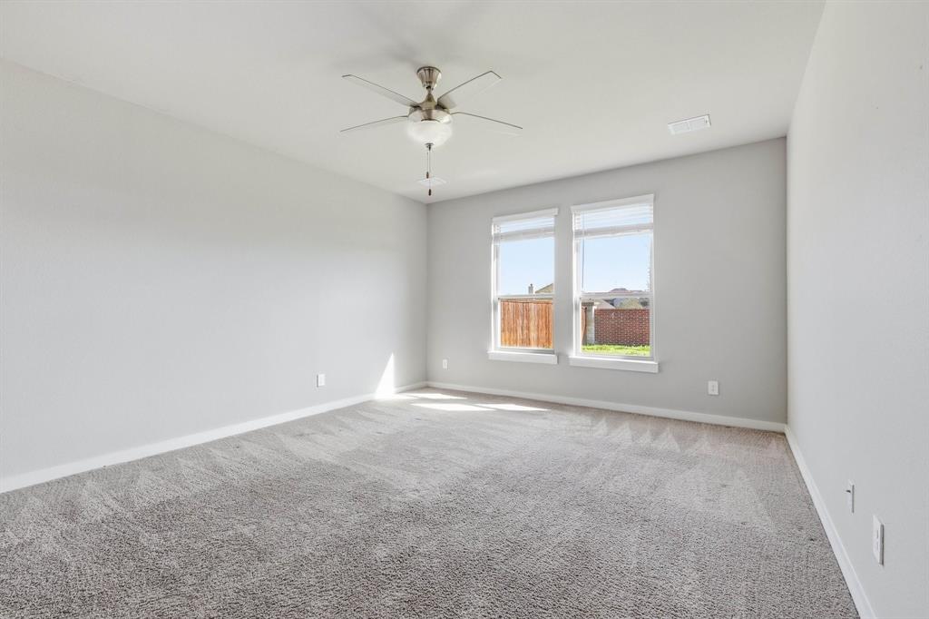 348 Braves Way Lavon, TX 75166 - Photo 16 of 26 an empty room with chandelier fan and windows