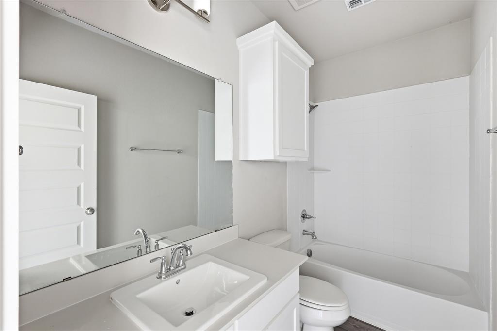 348 Braves Way Lavon, TX 75166 - Photo 17 of 26 a bathroom with a sink a toilet and shower