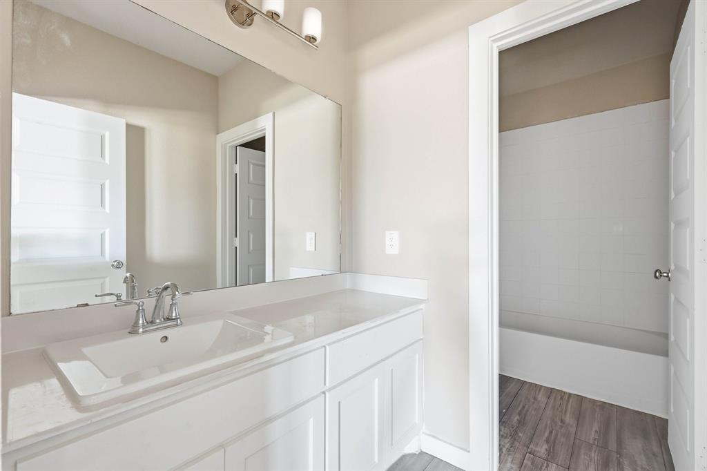 348 Braves Way Lavon, TX 75166 - Photo 19 of 26 a bathroom with a sink and a mirror