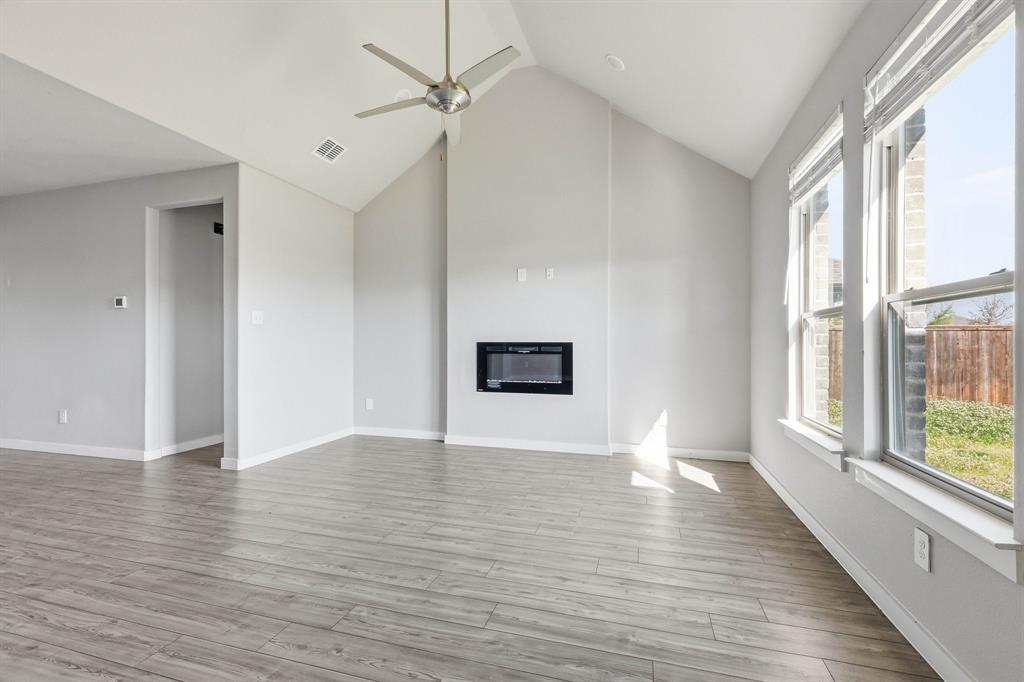 348 Braves Way Lavon, TX 75166 - Photo 3 of 26 a view of an empty room with wooden floor and a window