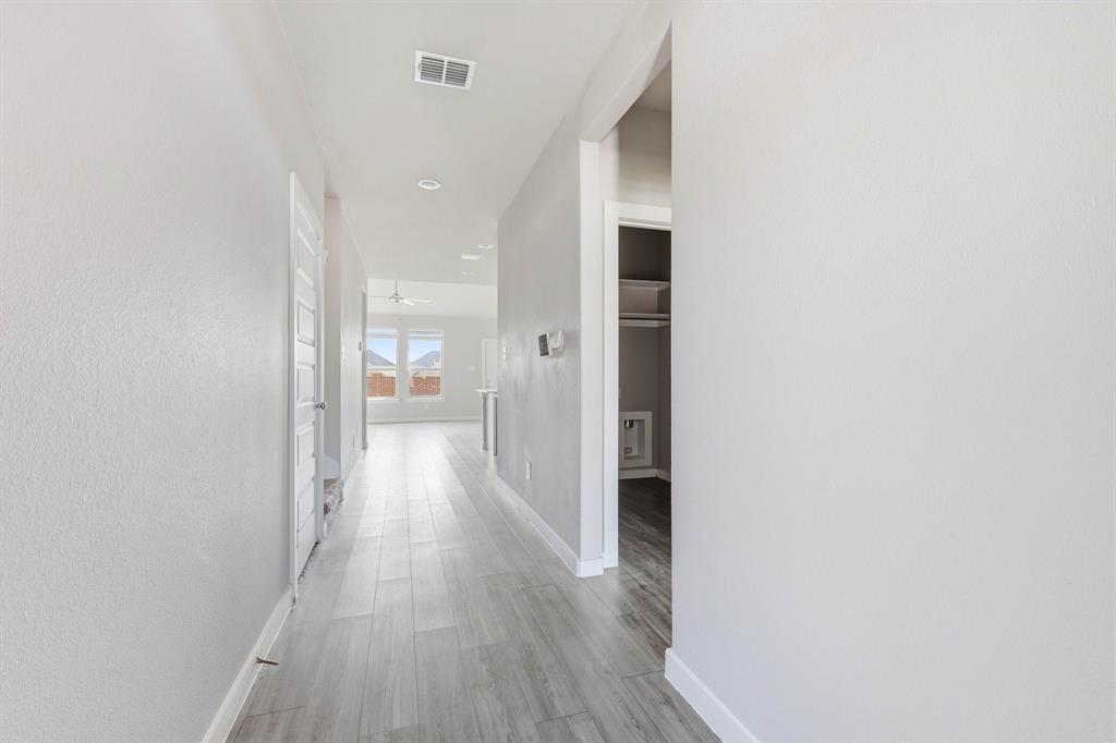 348 Braves Way Lavon, TX 75166 - Photo 6 of 26 a view of a hallway with wooden floor