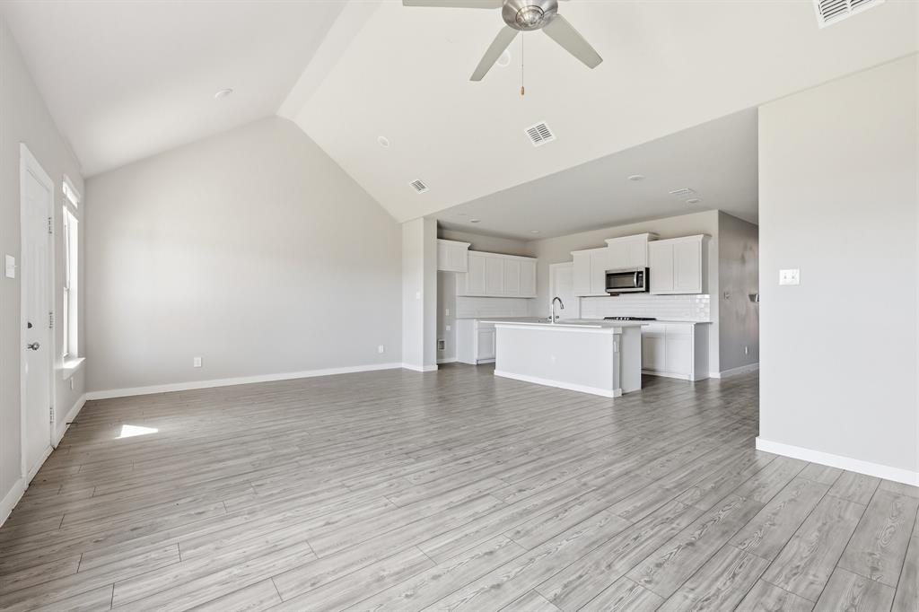 348 Braves Way Lavon, TX 75166 - Photo 7 of 26 a view of empty room with wooden floor and window