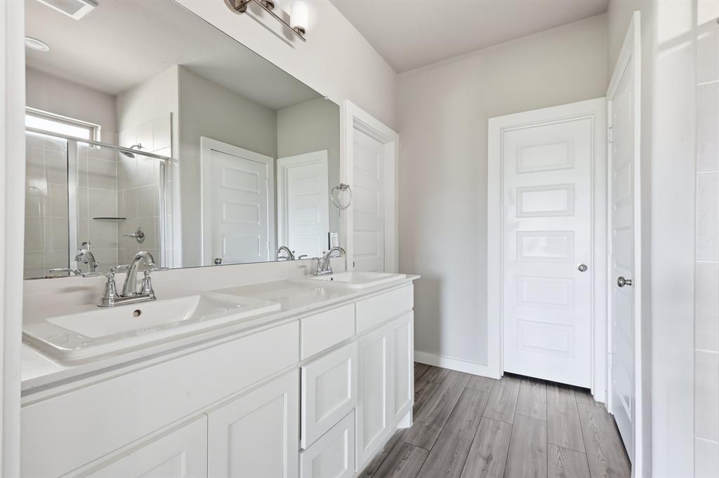 348 Braves Way Lavon, TX 75166 - Photo 9 of 26 a bathroom with a double vanity sink and mirror