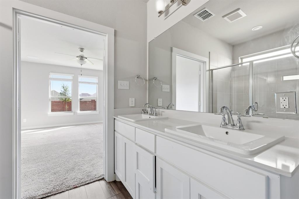 348 Braves Way Lavon, TX 75166 - Photo 10 of 26 a bathroom with 2 sink and a mirror