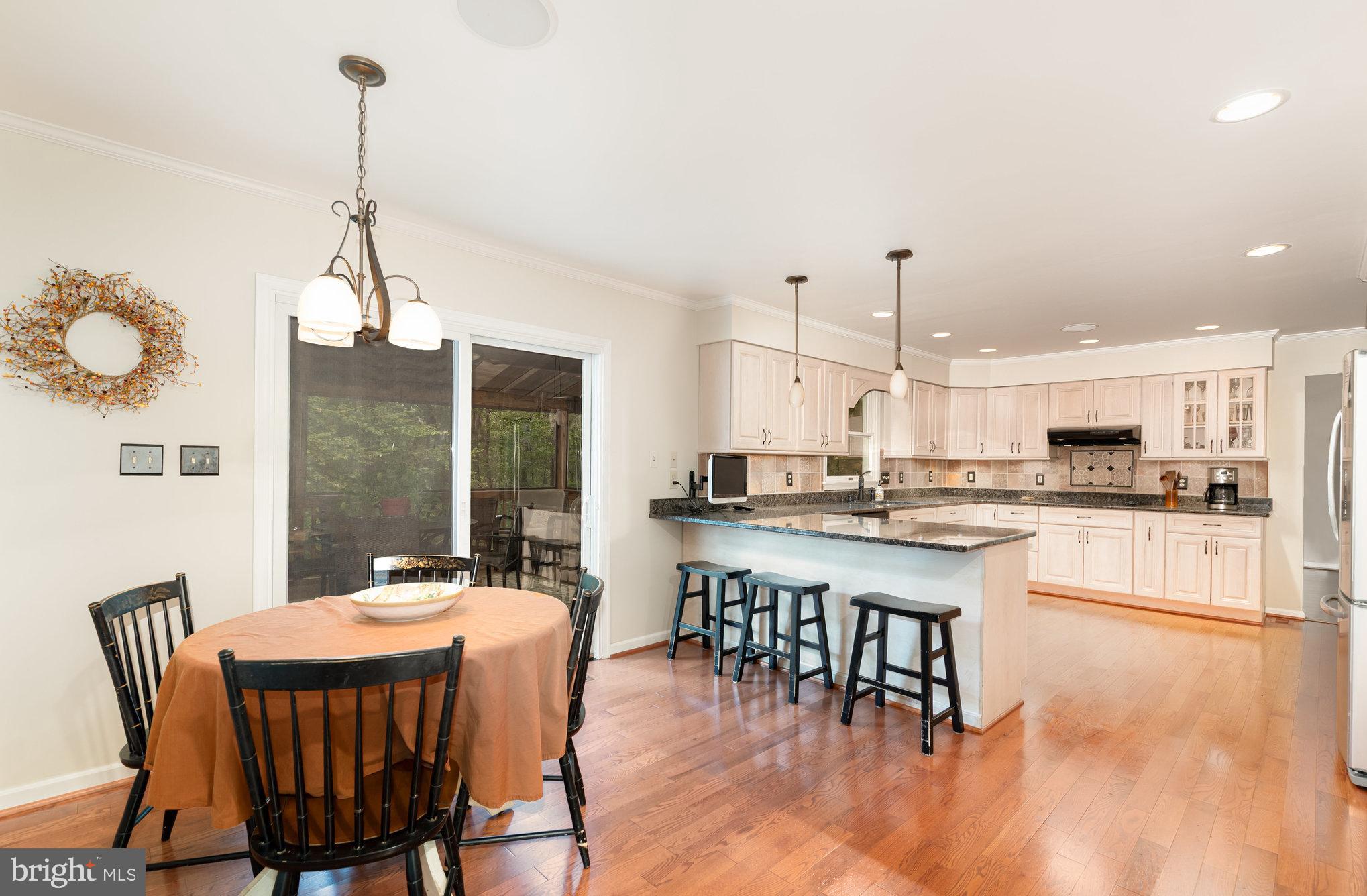 2736 Paper Mill Road Phoenix, MD 21131 - Photo 11 of 51 a dining area with a table chairs and a kitchen view