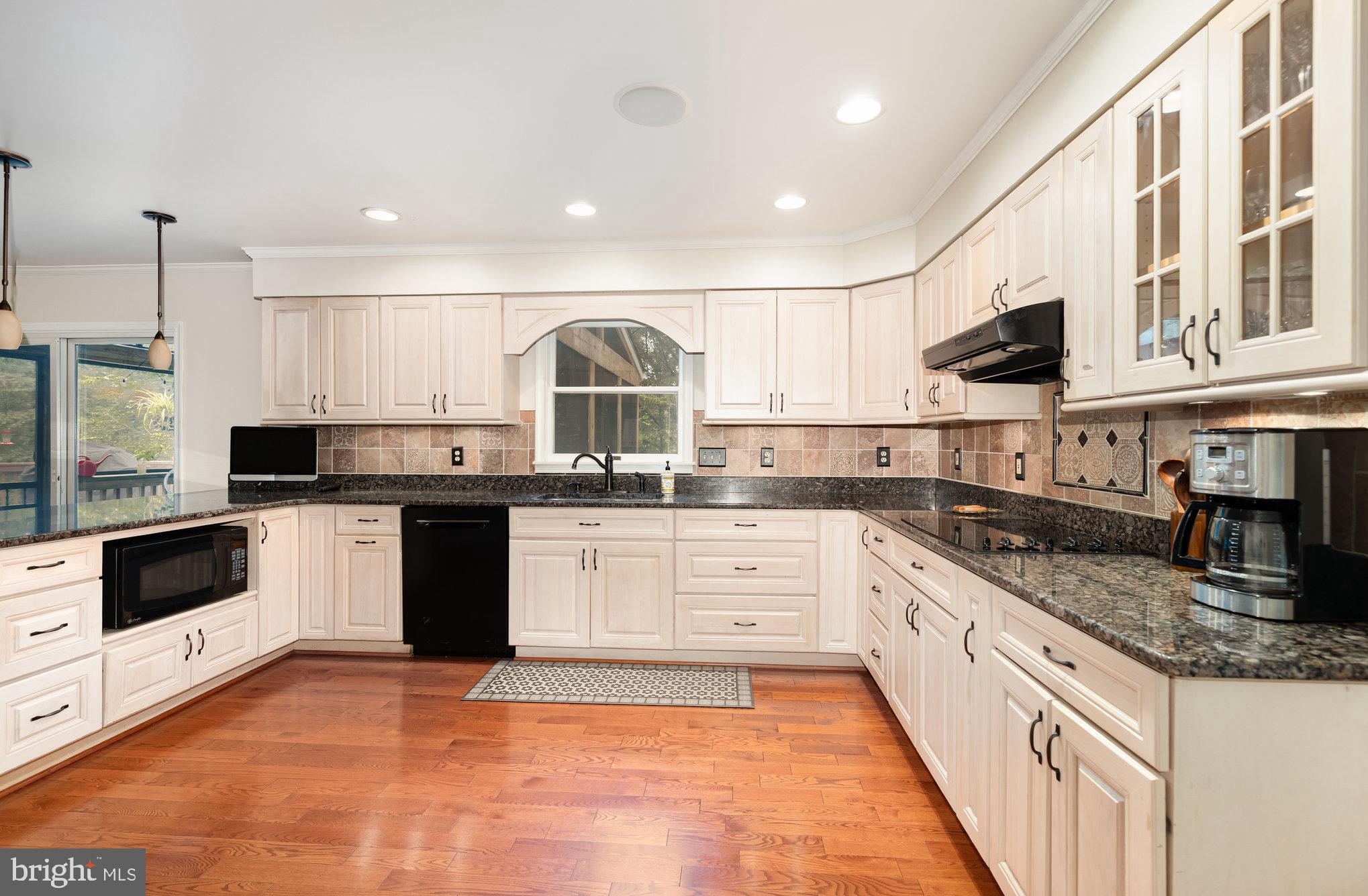 2736 Paper Mill Road Phoenix, MD 21131 - Photo 13 of 51 a kitchen with stainless steel appliances granite countertop a stove a sink and a microwave