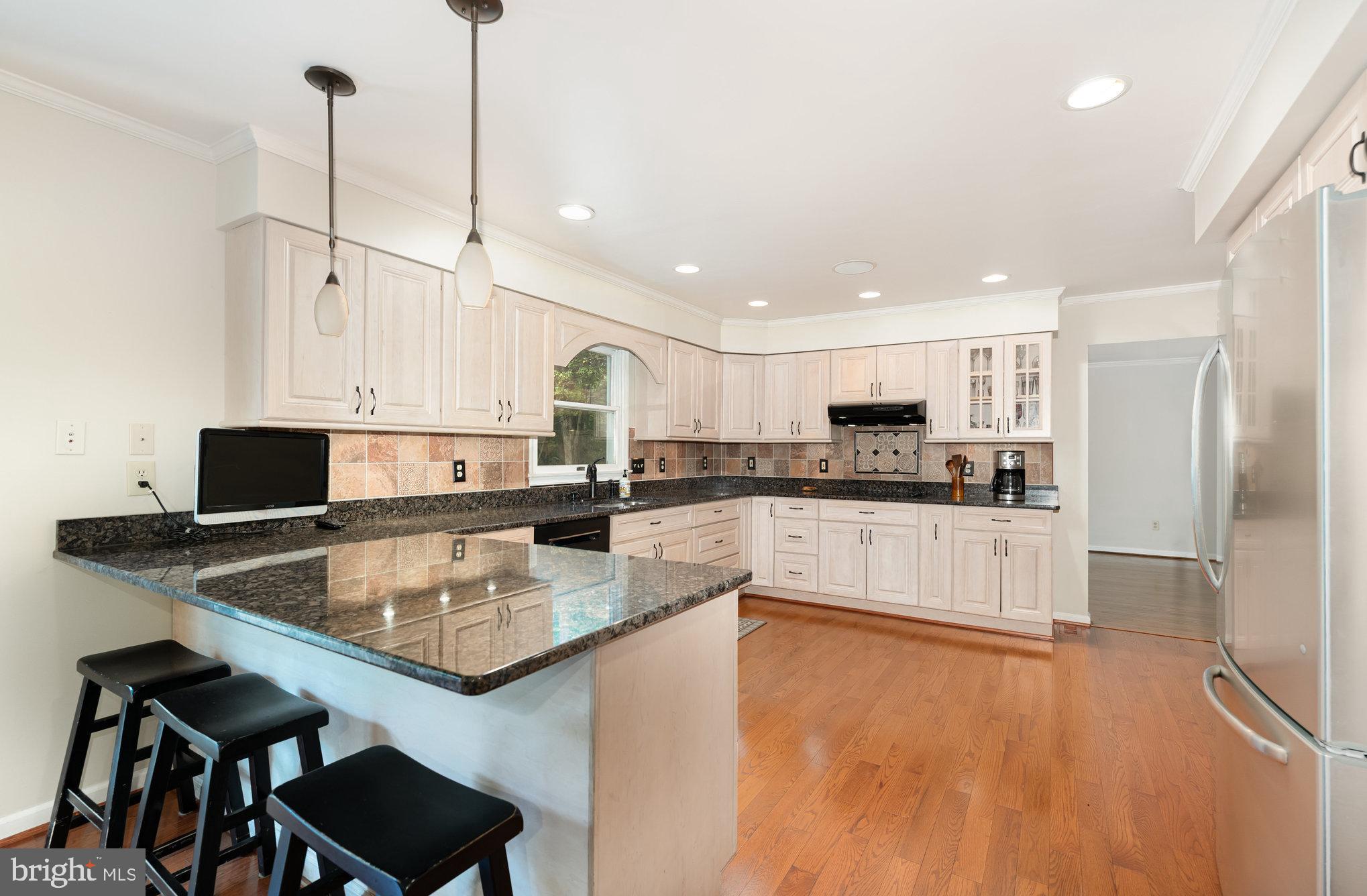 2736 Paper Mill Road Phoenix, MD 21131 - Photo 14 of 51 a kitchen with stainless steel appliances granite countertop a sink refrigerator and cabinets
