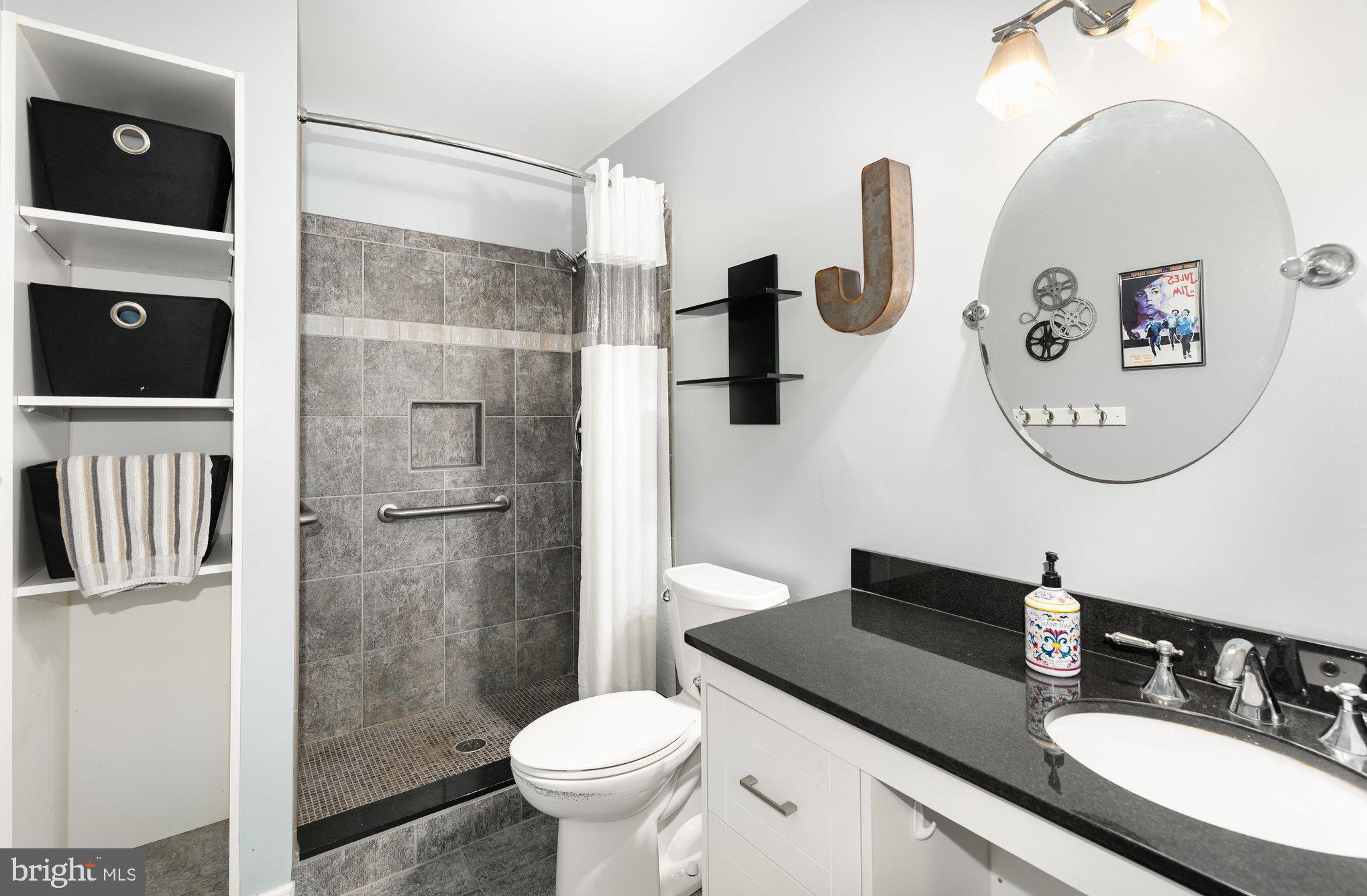 2736 Paper Mill Road Phoenix, MD 21131 - Photo 27 of 51 a bathroom with a granite countertop sink a toilet a mirror and shower