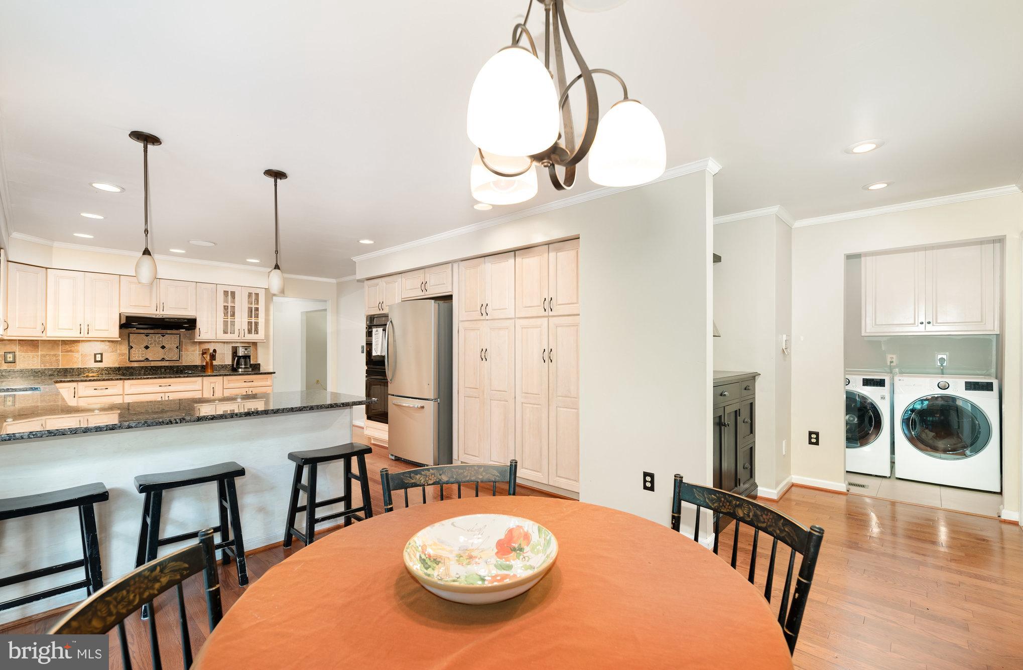 2736 Paper Mill Road Phoenix, MD 21131 - Photo 10 of 51 a view of a dining room and livingroom with furniture wooden floor a chandelier