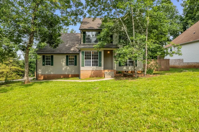 a backyard of a house with table and chairs