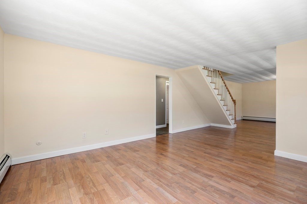 15 Ruthellen Road Chelmsford, MA 01824 - Photo 11 of 34 a view of an empty room with wooden floor and a window