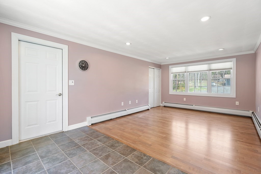 15 Ruthellen Road Chelmsford, MA 01824 - Photo 15 of 34 an empty room with wooden floor and windows