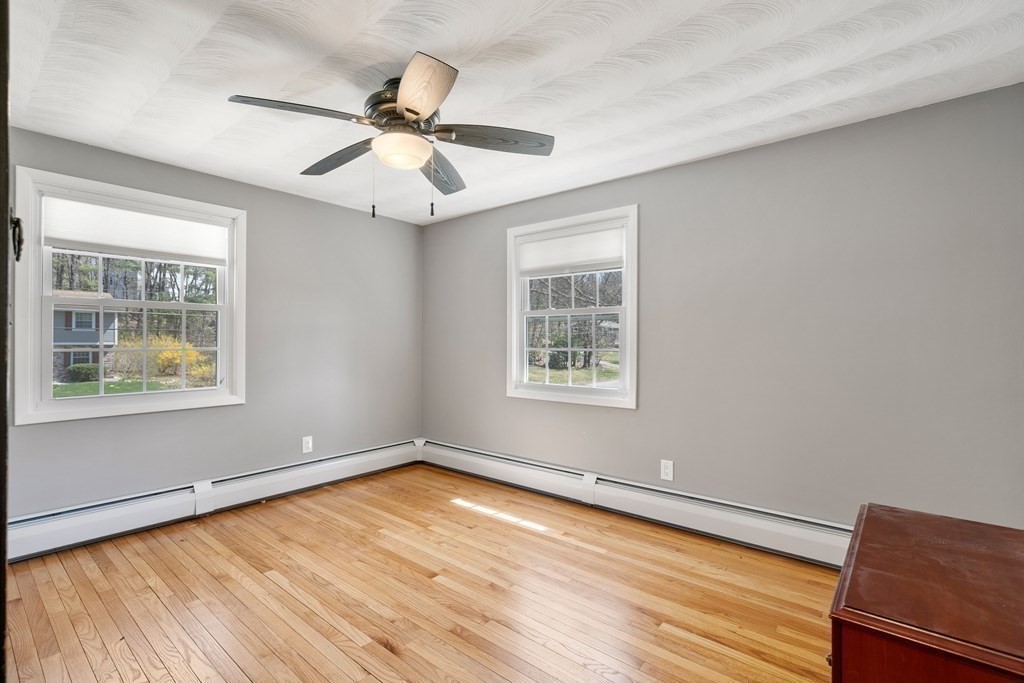 15 Ruthellen Road Chelmsford, MA 01824 - Photo 17 of 34 an empty room with wooden floor chandelier fan and windows