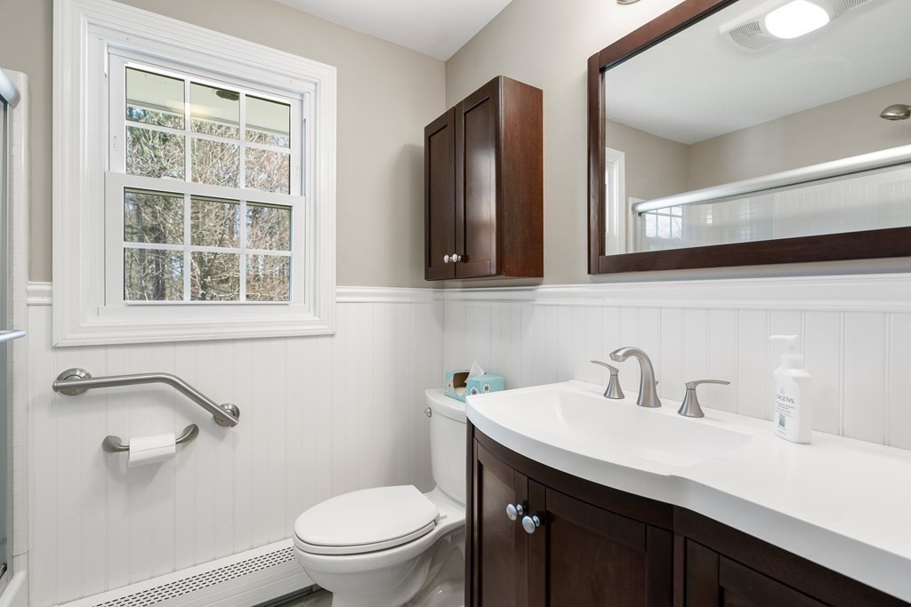 15 Ruthellen Road Chelmsford, MA 01824 - Photo 21 of 34 a bathroom with a sink a toilet and a mirror