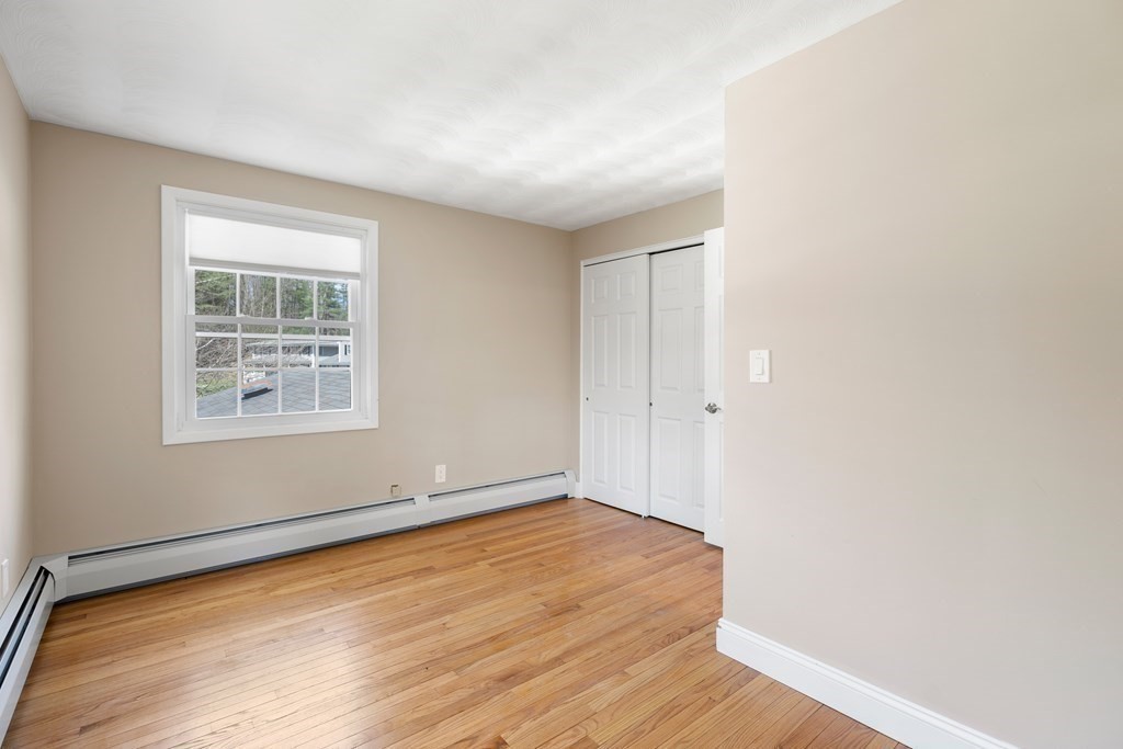 15 Ruthellen Road Chelmsford, MA 01824 - Photo 23 of 34 an empty room with wooden floor and windows