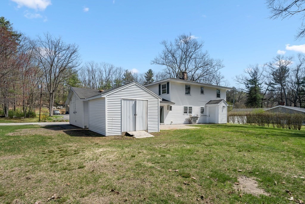 15 Ruthellen Road Chelmsford, MA 01824 - Photo 30 of 34 a view of a house with yard and trees in the background