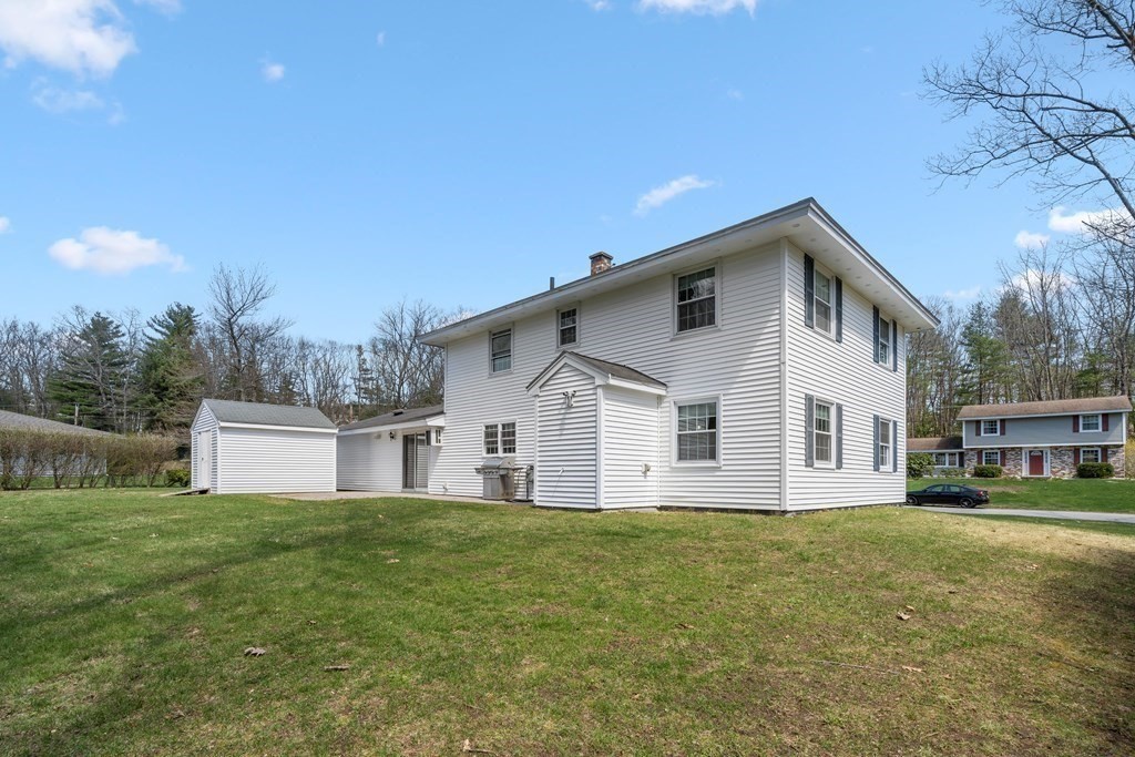 15 Ruthellen Road Chelmsford, MA 01824 - Photo 31 of 34 a front view of house with yard and trees in the background