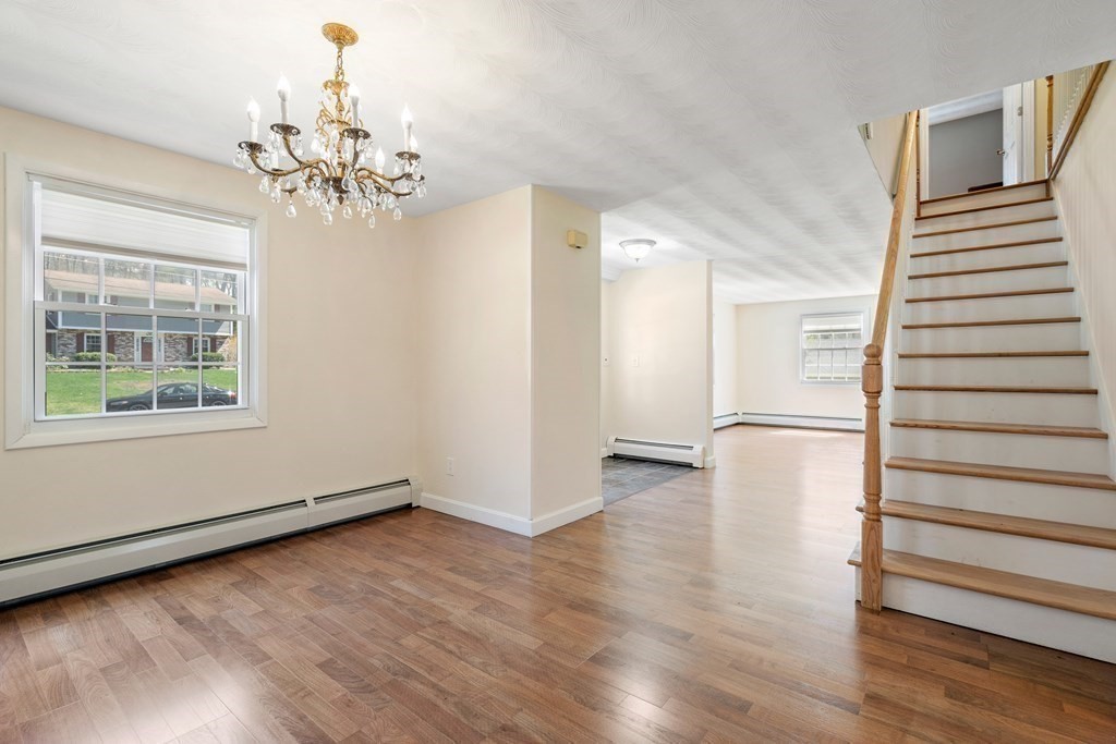 15 Ruthellen Road Chelmsford, MA 01824 - Photo 9 of 34 a view of a livingroom with wooden floor and stairs