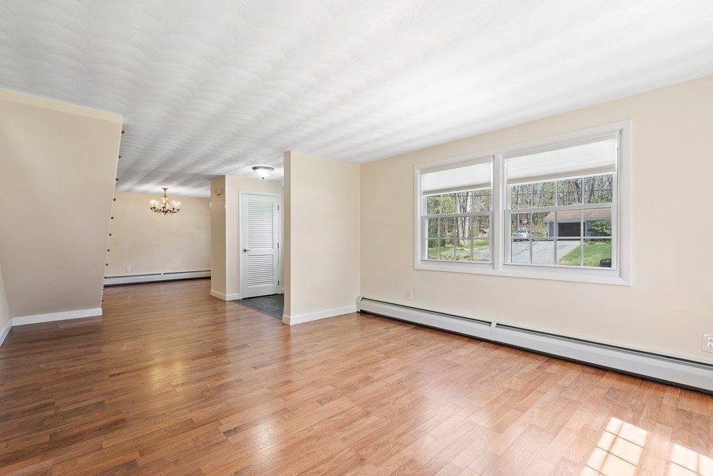 15 Ruthellen Road Chelmsford, MA 01824 - Photo 10 of 34 a view of an empty room with wooden floor and windows