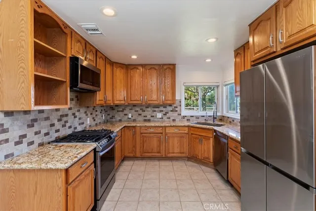 a kitchen with a sink stove top oven and cabinets