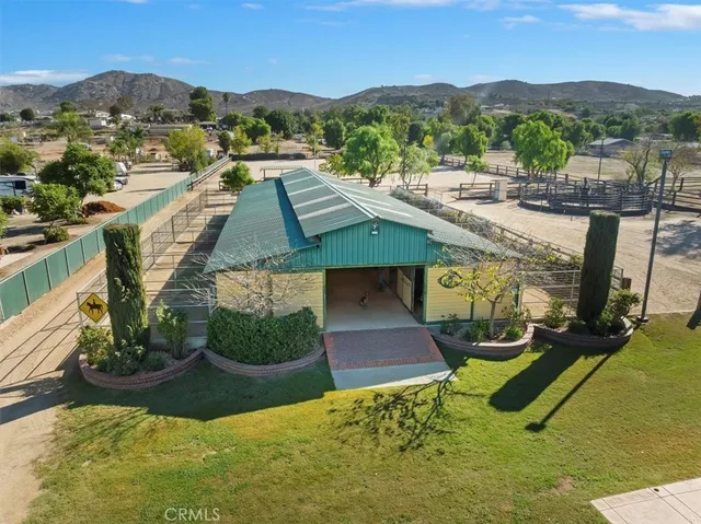 an aerial view of a house with swimming pool garden and outdoor seating