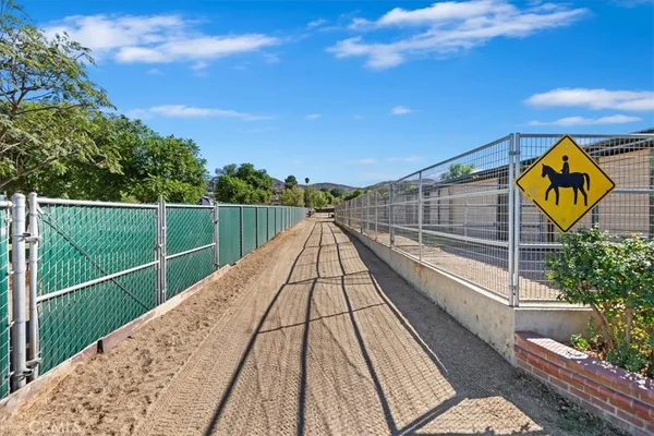 a view of a pathway with a wrought fence