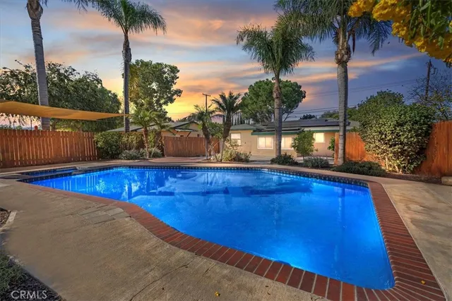 an aerial view of a house with swimming pool garden and outdoor seating