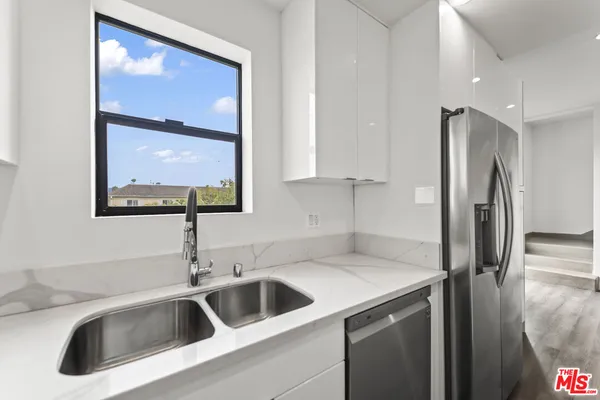 a kitchen with a sink and a refrigerator