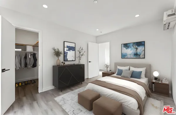 a bedroom with a bed and a walk in closet