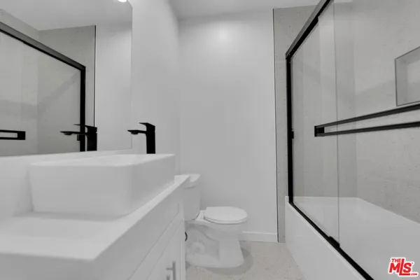 a bathroom with a toilet a sink and bathtub