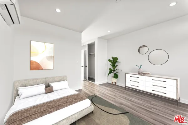 a bedroom with a bed and a dresser