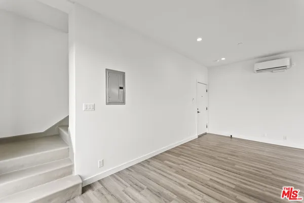a view of a room with wooden floor