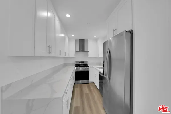 a kitchen with a refrigerator and a sink