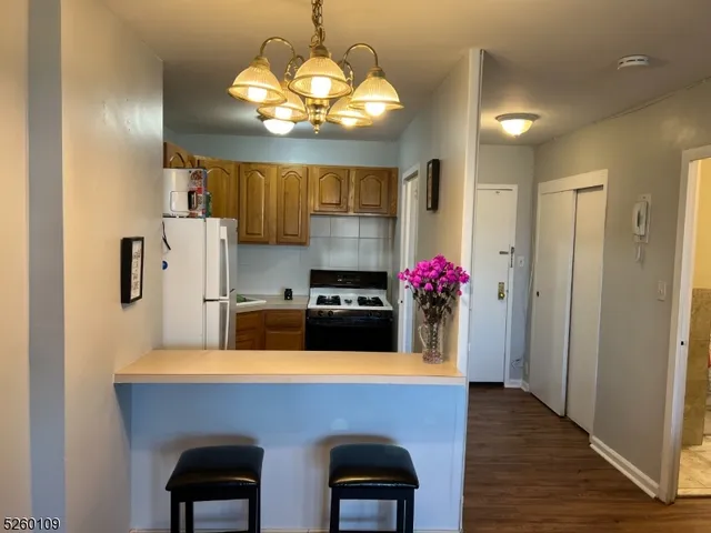 a kitchen with stainless steel appliances a sink cabinets and wooden floor