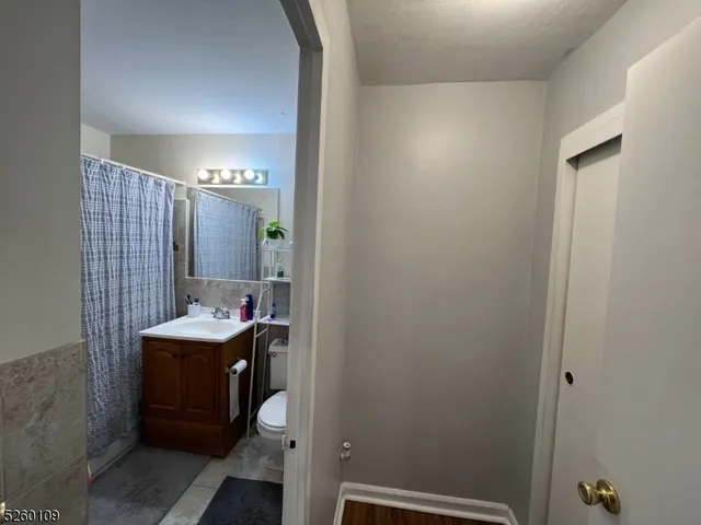 a bathroom with a sink a toilet and mirror