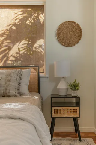 a bedroom with a bed and a painting on the wall