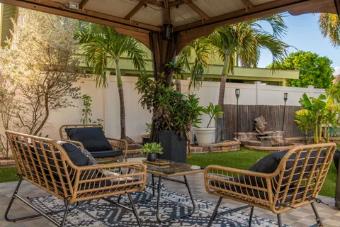a view of porch with a table chairs and a potted plant