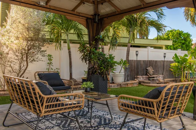 a view of porch with a table chairs and a potted plant