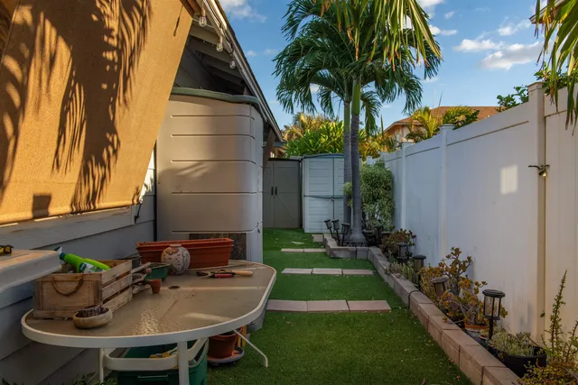 a backyard of a house with table and chairs